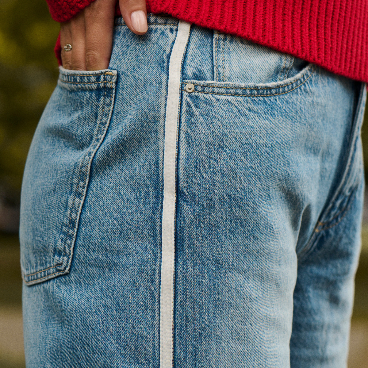 woman wearing denim jeans with hand in back pocket