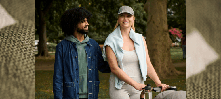 parents walking in a park with stroller wearing cotton clothes